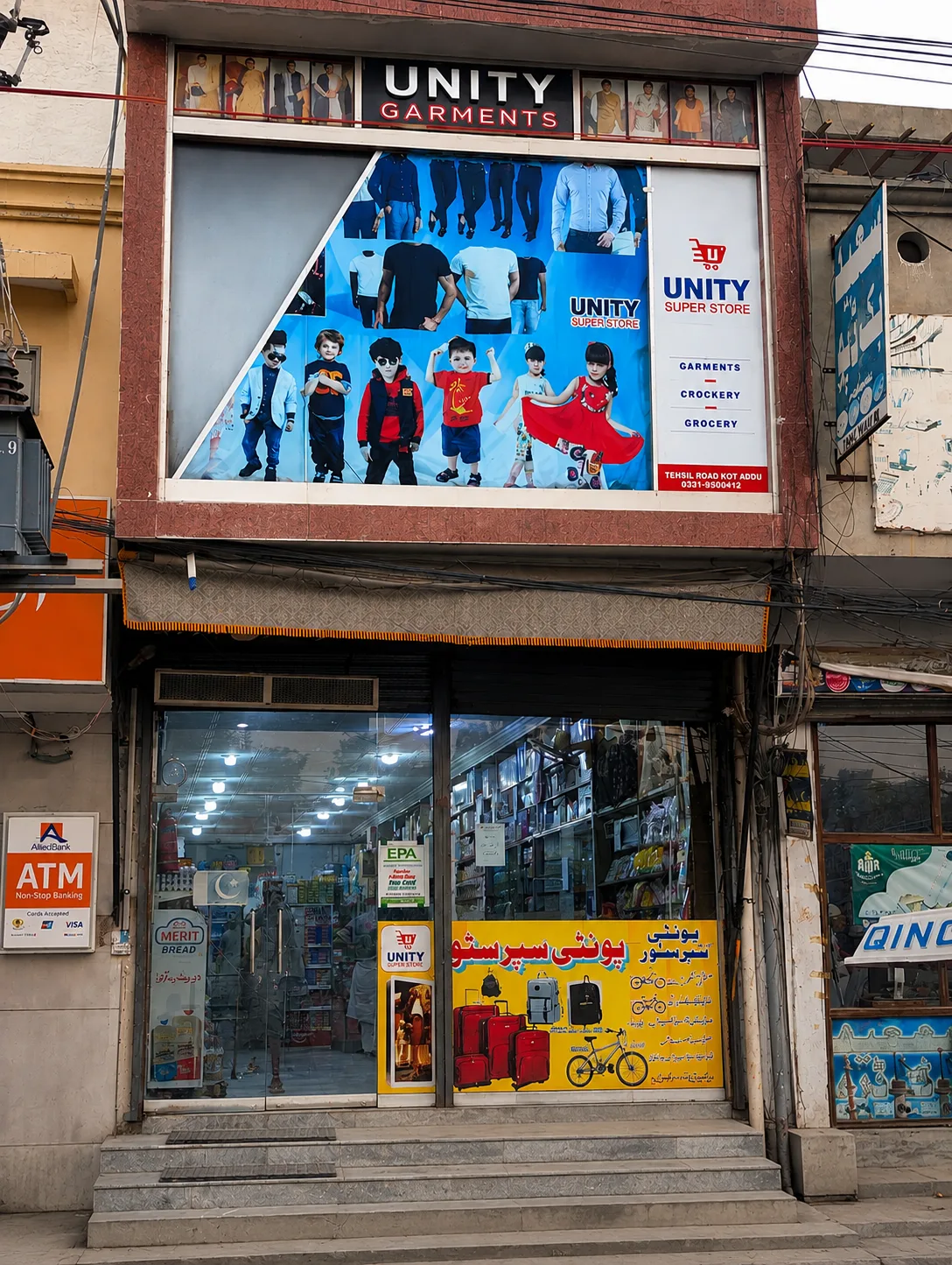 Unity Super Store shopfront on Thana Road, Kot Addu, with the Unity Garments sign above the entrance